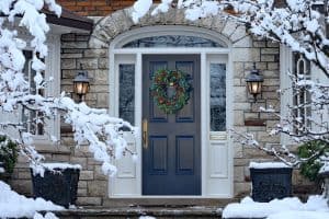 Front,Door,In,Winter,With,Seasonal,Wreath,,Surrounded,By,Snow